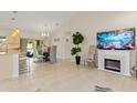Open-concept dining area with modern lighting, an electric fireplace, and patio access at 3138 Darius Ave, North Port, FL 34288