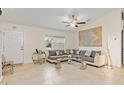 Bright living room featuring tile flooring, a large sectional sofa, and stylish decor at 3138 Darius Ave, North Port, FL 34288