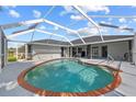 Inviting screened-in pool with brick trim, perfect for relaxation and outdoor entertainment in a private setting at 411 Scarlet Sage, Punta Gorda, FL 33955