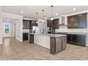 Open concept kitchen with large center island, granite countertops, and stainless steel appliances at 42346 Waterfront Way, Punta Gorda, FL 33982