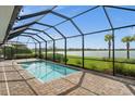 Screened pool with serene lake view, perfect for relaxation and outdoor entertainment at 42346 Waterfront Way, Punta Gorda, FL 33982