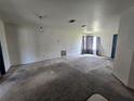 Spacious living room with neutral walls, drop ceiling with lights and picture window with curtains at 4424 Baroda Ave, North Port, FL 34287