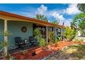 Charming covered patio with seating and lush landscaping at 611 Bonita Ct, Punta Gorda, FL 33950