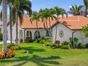 Beautiful one-story home with a tile roof, lush landscaping, and a well-maintained lawn at 632 Brindisi Ct, Punta Gorda, FL 33950