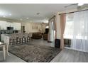 Open living space featuring an island kitchen with ample seating and views of the pool at 6794 Loffreda Ave, North Port, FL 34291