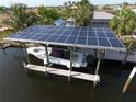 Aerial view of boat dock with solar panels, providing shade and power for marine activities at 107 Sinclair Se St, Port Charlotte, FL 33952