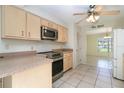 Bright kitchen featuring light wood cabinets, stainless steel appliances, and tile flooring at 1472 Oriel Ct, Punta Gorda, FL 33983