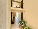 Hallway with multiple doors and a view of the outdoors, showing a well-lit and accessible entrance to units at 1515 Forrest Nelson Blvd # D102, Port Charlotte, FL 33952
