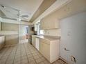 Kitchen with ample cabinet space, tile floors, and modern appliances at 1611 Robbins Rd, Nokomis, FL 34275