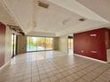 Bright living room featuring tile floors and sliding glass doors to the pool at 1611 Robbins Rd, Nokomis, FL 34275