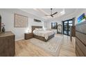 Relaxing main bedroom with wood floors, tray ceilings, a ceiling fan and views of the water at 1801 Los Alamos Dr, Punta Gorda, FL 33950