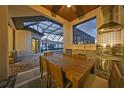 Outdoor kitchen featuring wood ceiling, stainless steel grill, sink and backsplash at 1801 Los Alamos Dr, Punta Gorda, FL 33950