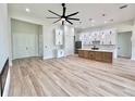 Expansive open layout featuring elegant flooring, a modern ceiling fan, and seamless flow between living areas at 2089 Garnet St, North Port, FL 34288