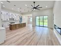 Spacious open floor plan with hardwood floors and modern fixtures throughout the home at 2089 Garnet St, North Port, FL 34288