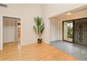 Bright entryway with wood floors, ample closet space, and decorative security door at 2160 Aqui Esta Dr, Punta Gorda, FL 33950