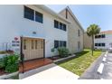 Exterior view shows maintained landscaping and a brick entry to the condominium building at 22481 Westchester Blvd # B48, Punta Gorda, FL 33980