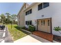 Close-up of the condo's entry showcases a well-kept lawn and a brick-paved entry at 22481 Westchester Blvd # B48, Punta Gorda, FL 33980