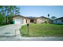 Well maintained home with stone facade, solar panels, and green lawn at 23273 Abeline Ave, Punta Gorda, FL 33980