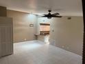 Bright living room with tile flooring, modern ceiling fan and a view of the adjacent kitchen at 3300 Loveland Blvd # 602, Punta Gorda, FL 33980
