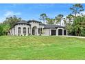 Sprawling two-story home showcasing a manicured lawn and three-car garage at 3393 S Haberland Blvd, North Port, FL 34288