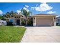 Beautiful single Gathering home with a lush green lawn and a spacious driveway at 4294 Wooley Ave, North Port, FL 34287