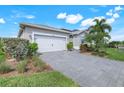 Beautiful single-Gathering home with a gray paved driveway at 43249 Treadway Dr, Punta Gorda, FL 33982