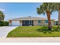 Well-maintained single-story home with a screened in porch and an extra-long concrete driveway at 444 Edgewood Rd, Venice, FL 34293