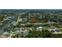 Aerial view of a waterfront community with lush landscaping and private canals at 13471 Chenille Dr, Port Charlotte, FL 33981
