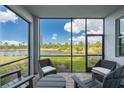 Inviting screened lanai offers serene water views, complete with comfortable seating perfect for relaxation at 14141 Heritage Landing Blvd # 912, Punta Gorda, FL 33955
