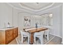 Dining room with elegant lighting, a dining table, and a decorative cabinet at 15039 Black Cherry Way, Punta Gorda, FL 33955
