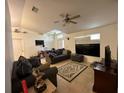 Cozy living room featuring tile floors, neutral walls, ceiling fan and a comfortable seating arrangement at 1609 Log Ln, North Port, FL 34286