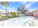 Inviting backyard pool, perfect for relaxation with lounge chairs and palm trees surrounding at 2031 Backton St, Port Charlotte, FL 33948