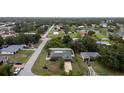 Aerial view of a home with a well-maintained yard, showcasing its location in a residential neighborhood at 21220 Pemberton Ave, Port Charlotte, FL 33952