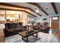 Inviting living room featuring exposed beams, hardwood floors, and comfortable leather seating at 21220 Pemberton Ave, Port Charlotte, FL 33952