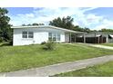 Inviting single-story home with a tidy front yard, new exterior paint, and an attached carport at 22334 Augusta Ave, Port Charlotte, FL 33952