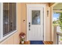 Elegant front entrance with a decorative glass door, complemented by a charming porch and stylish accents at 24398 Treasure Island Blvd, Punta Gorda, FL 33955