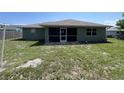Backyard view featuring a screened lanai, and a big yard at 2443 Lake View Blvd, Port Charlotte, FL 33948