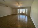 Bright living room with tile flooring, ceiling fan, and natural light at 2443 Lake View Blvd, Port Charlotte, FL 33948