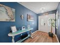 Inviting entryway with blue accent wall, wood-look flooring, and decorative console table at 26125 Copiapo Cir, Punta Gorda, FL 33983