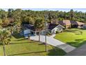Aerial view of home with long driveway, lush landscaping, private pool and canal at 372 Cory St, Port Charlotte, FL 33953