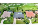 Aerial view of home on the golf course with a pool and a dark tile roof at 3724 Bordeaux Dr, Punta Gorda, FL 33950