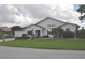 Bright single-story home featuring a well-manicured lawn, mature landscaping, and brick driveway at 3724 Bordeaux Dr, Punta Gorda, FL 33950