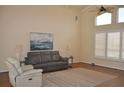 Spacious living room boasting vaulted ceilings, with clerestory windows, and a ceiling fan at 3724 Bordeaux Dr, Punta Gorda, FL 33950