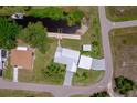 Bird's-eye view of a well-kept home and dock, revealing its location near a tranquil canal at 405 Ridgecrest Dr, Punta Gorda, FL 33982
