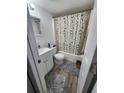 Cozy bathroom featuring a shower with a decorative curtain and grey accent rugs at 4158 Tamiami Trl # U4, Port Charlotte, FL 33952