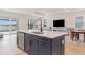 Open kitchen with island flows into the living area, offering views of the pool at 42771 Valley Brooks St, Punta Gorda, FL 33982