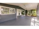 The screened patio has a ceiling fan and painted floor at 4371 Guard St, Punta Gorda, FL 33980
