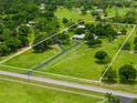 Aerial view showcasing the vast property boundaries and the home's idyllic setting amidst lush greenery at 5221 Blackjack Cir, Punta Gorda, FL 33982