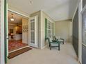 Cozy screened porch featuring comfortable seating and a view into the living area at 5221 Blackjack Cir, Punta Gorda, FL 33982