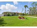 Sprawling green lawn in front of this single-story home with solar panels at 5273 Crestline Ter, Port Charlotte, FL 33981